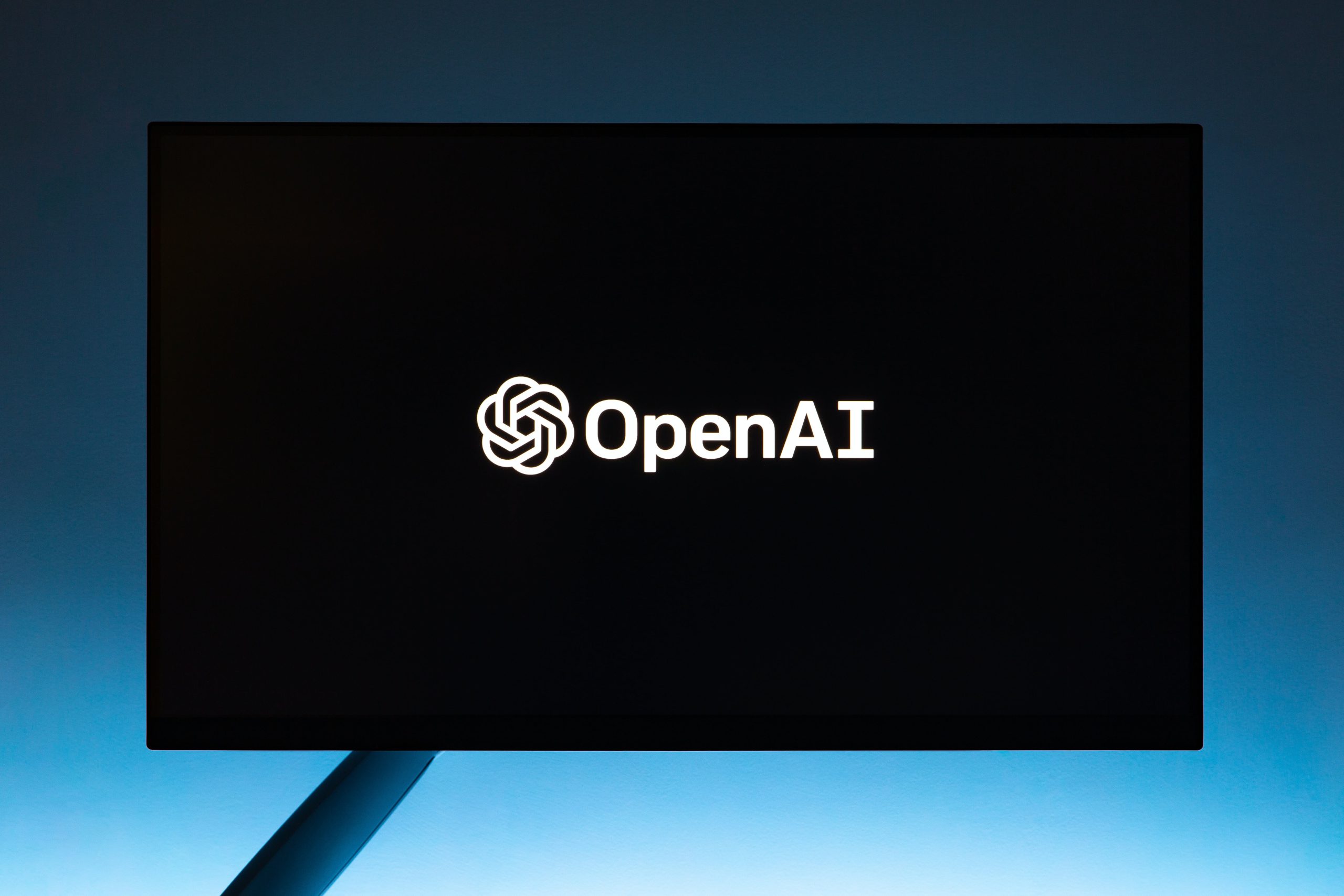 Monitor displaying The OpenAI Logo